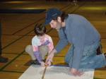 Search and rescue volunteer John Pickens demonstrates use of a tracking stick to Liam Demko Saturday night.